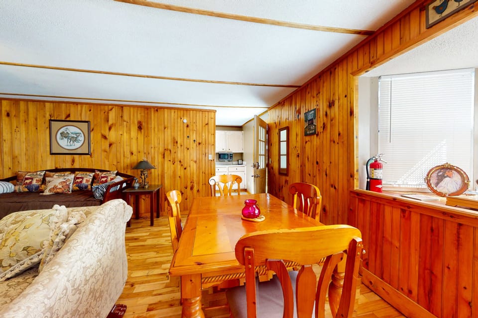Delight, and gather around the rustic table in a warm, wood-paneled retreat!