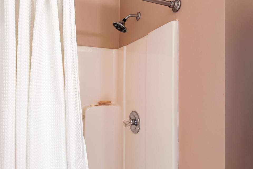 Refresh in a spacious shower with elegant fixtures and bright ambiance!