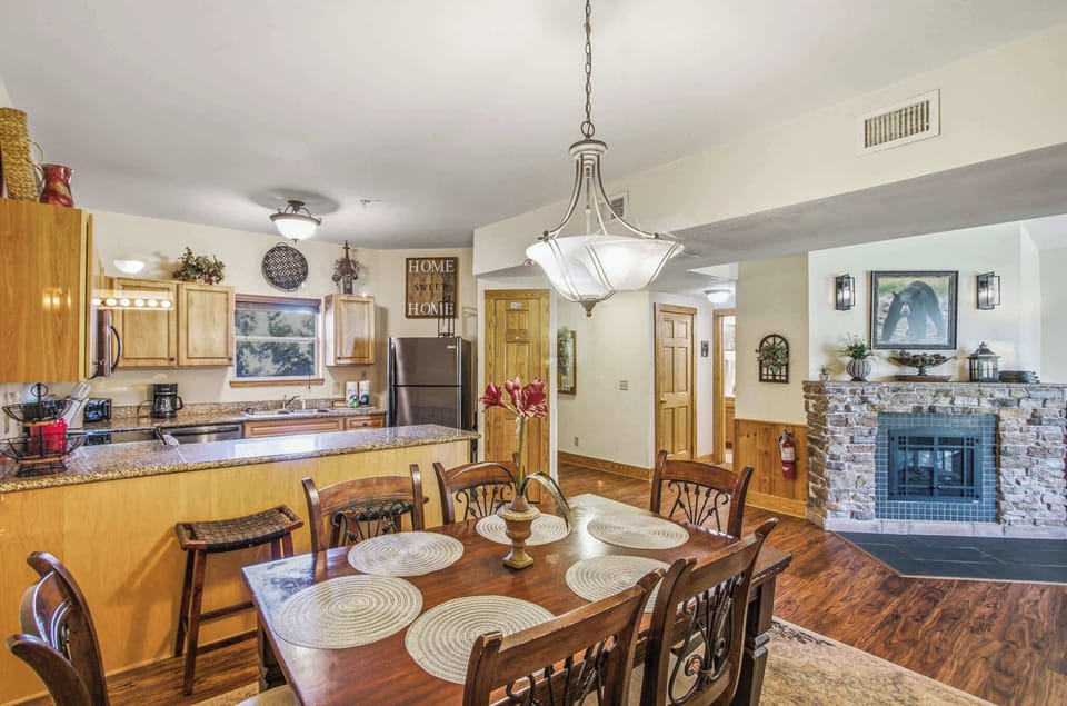 Dining Room, gather around the stunning table and enjoy warmth from the stylish stone fireplace!