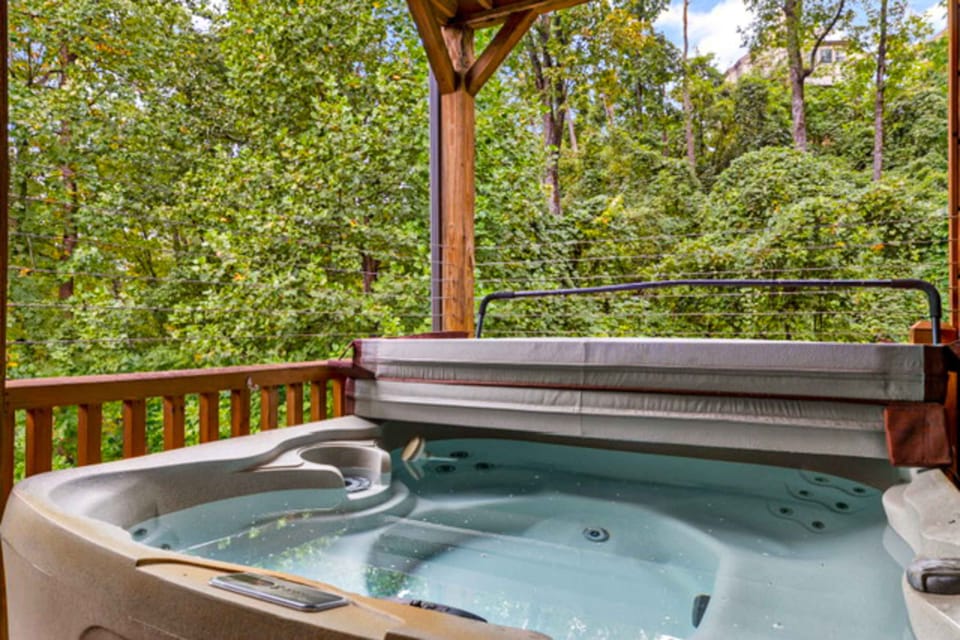Outdoor oasis awaits. And, unwind in the hot tub surrounded by lush greenery and serene mountain views!