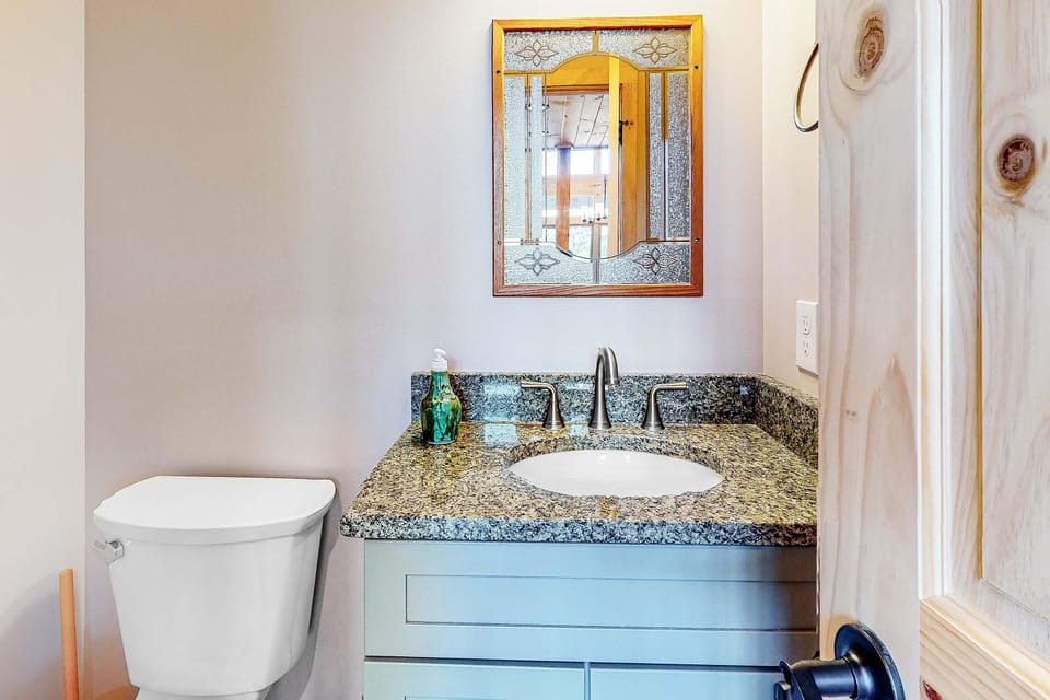 Bathroom Bliss, elegant granite countertops and a stylish mirror for your refreshing retreat!