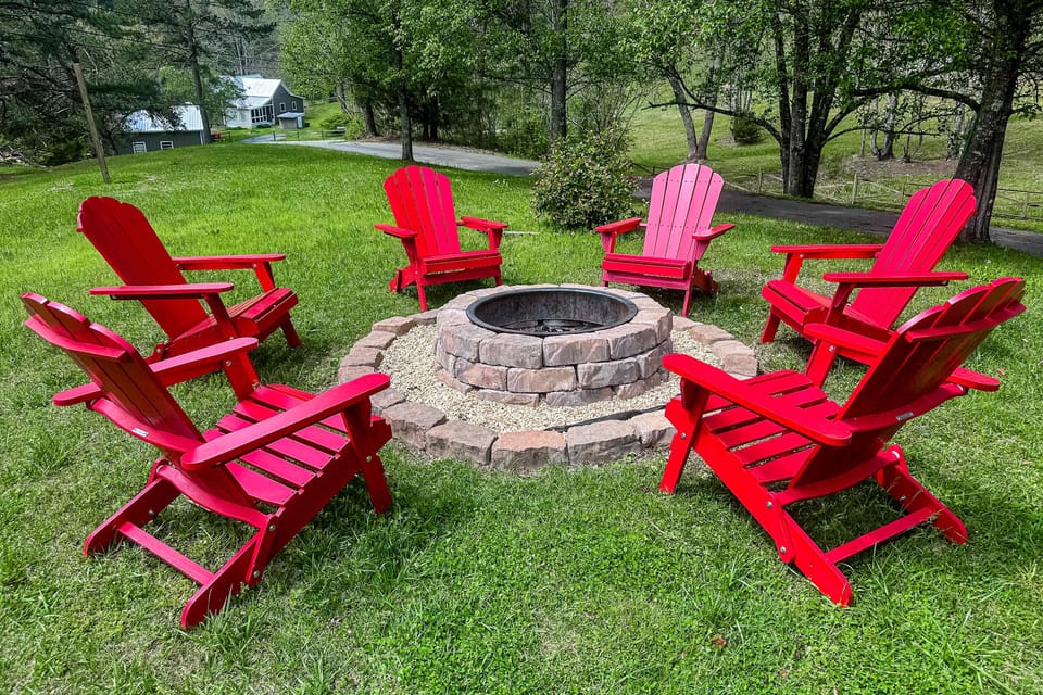 Fire Pit Gathering, bright red chairs invite laughter and stories around the warm glow of a fire!