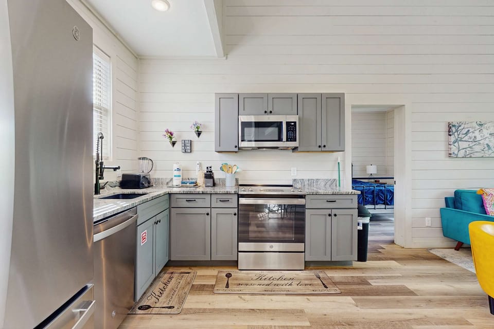 Modern kitchen awaits. And, cook up a storm in this stylish space with stainless steel appliances and charm!