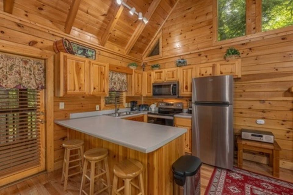 Elegant wood accents and modern appliances make cooking a delight in nature’s embrace!