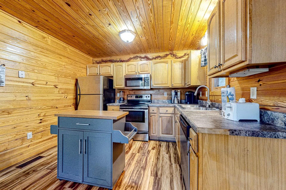 Kitchen oasis awaits. Complete with modern appliances and rustic charm await your culinary adventures!