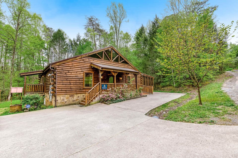 Delight in this rustic cabin, surrounded by lush greenery and inviting porches!