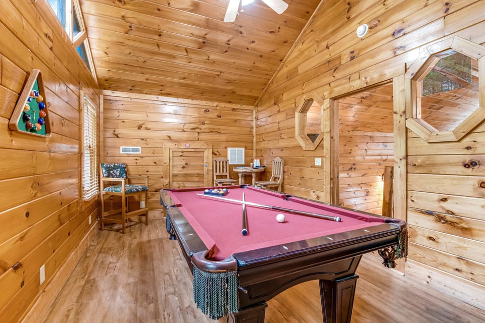 Challenge friends to a pool match in this spacious, wood-paneled game room!