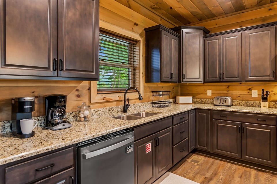 Culinary adventures await in this stylish kitchen with granite counters and panoramic views!