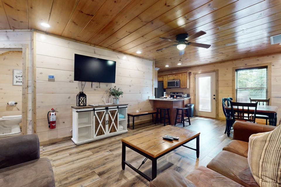 Gather around the charming wooden coffee table in this inviting open space!