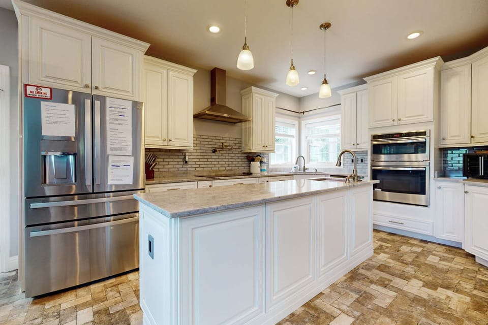 Gourmet kitchen with sleek design, ample light, and modern amenities awaits!