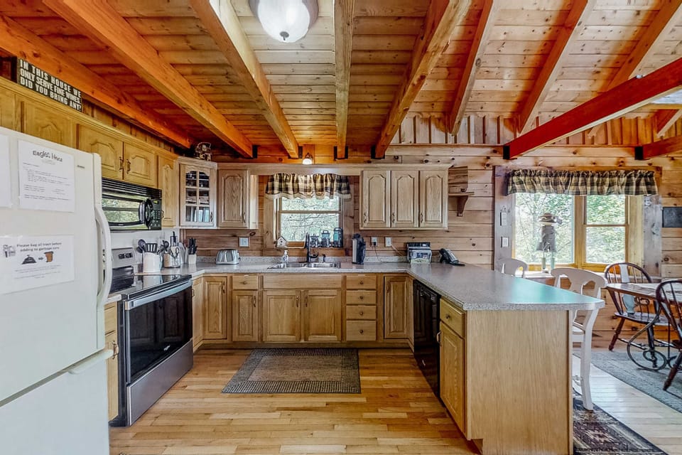 Enjoy cooking in this bright, rustic space with stunning wooden beams and mountain views!