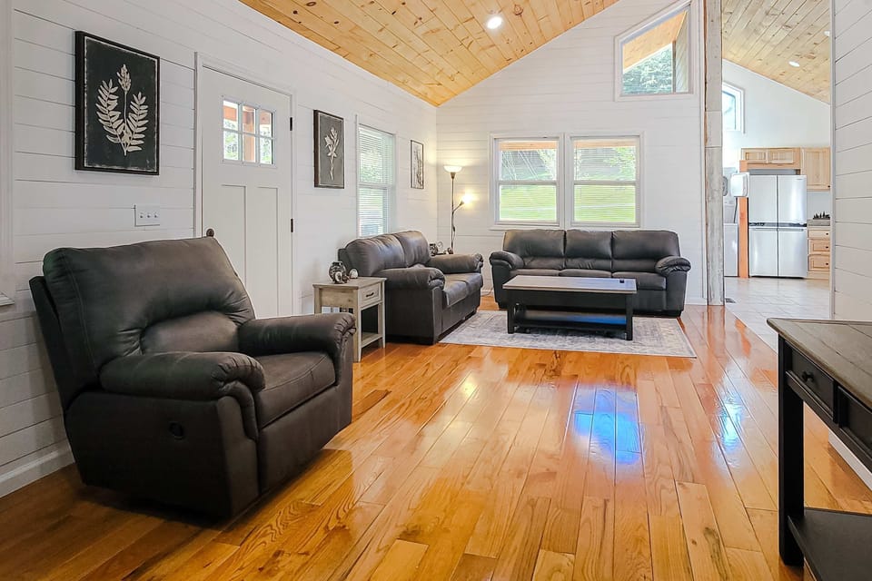 Living room retreat awaits. Sun-drenched space with comfy seating and modern decor, perfect for relaxation!