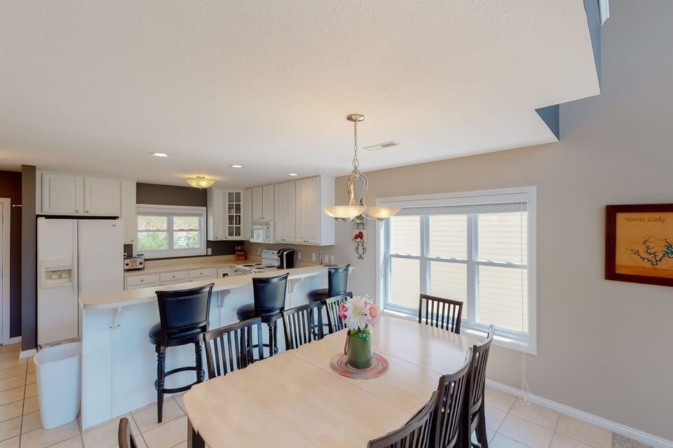 Spacious dining area with breakfast bar seating and open kitchen flow. Ideal for group meals, game nights, and entertaining.