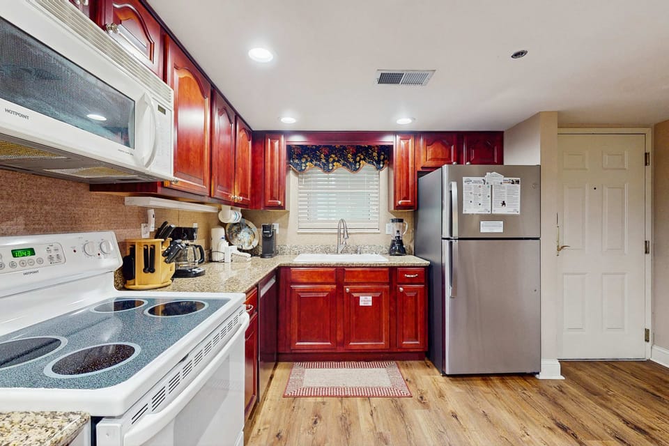 Craft gourmet meals in this elegant kitchen featuring rich cabinetry and modern appliances!