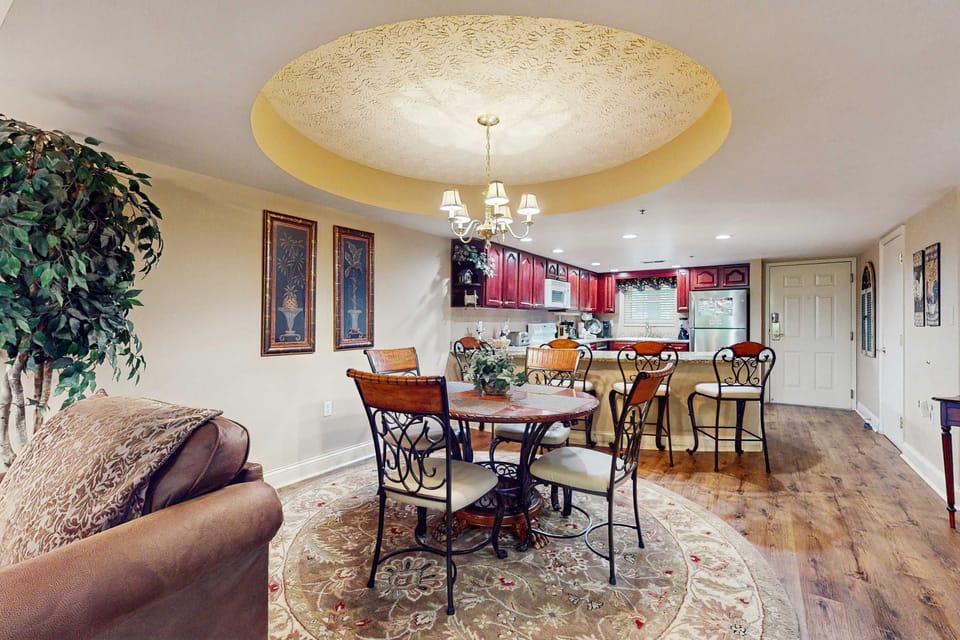 Savor meals under a stunning chandelier in this stylish, inviting dining space!