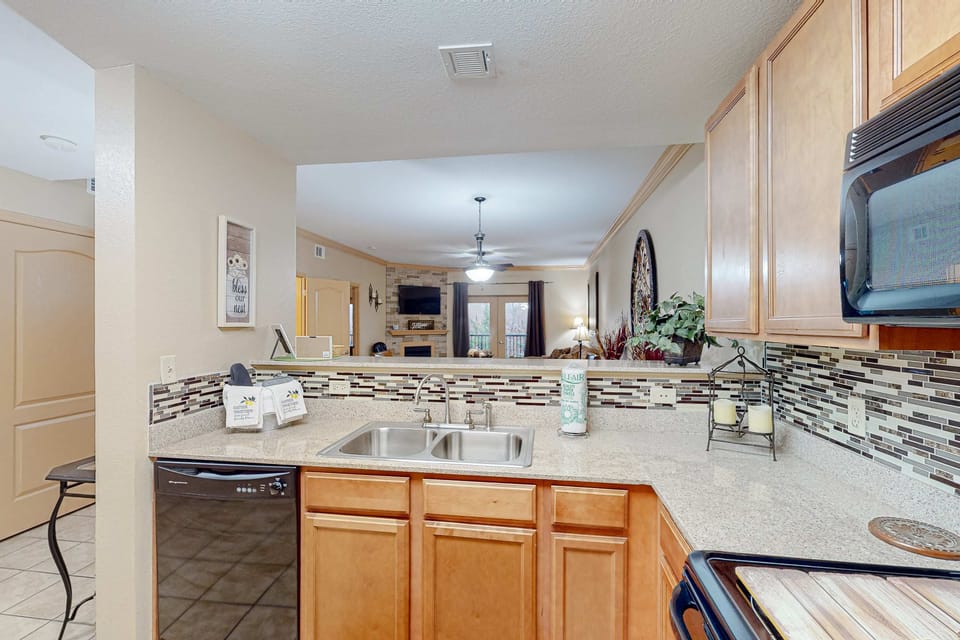 Clean, functional kitchen with double sink, dishwasher, and modern finishes. Ideal for longer stays and family trips.