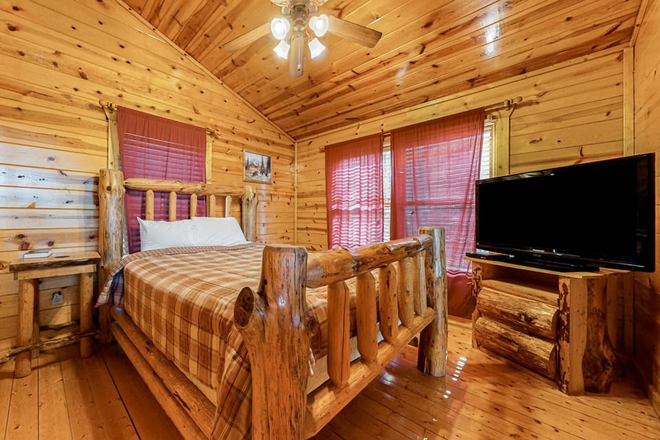 Log Cabin Retreat, rustic charm awaits in this inviting bedroom with stunning wood accents!