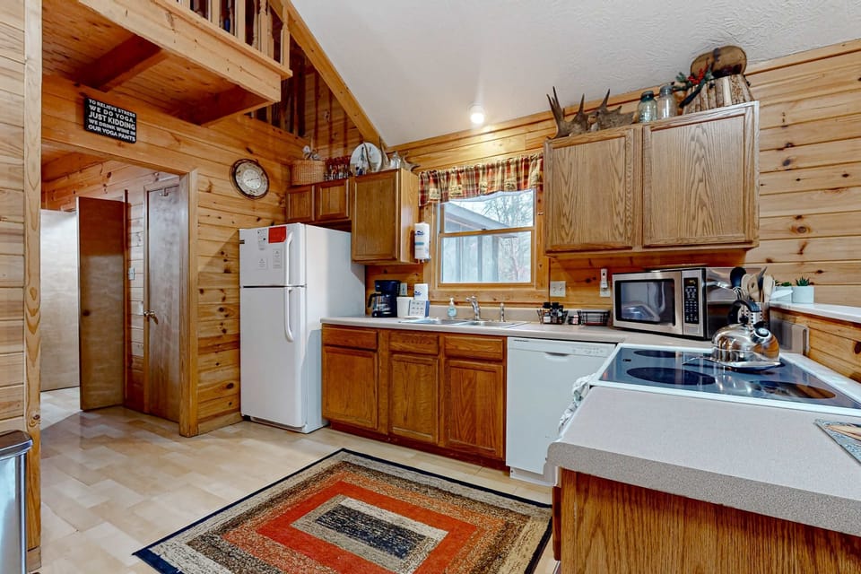 Whip up culinary delights in this rustic wooden kitchen with modern appliances!