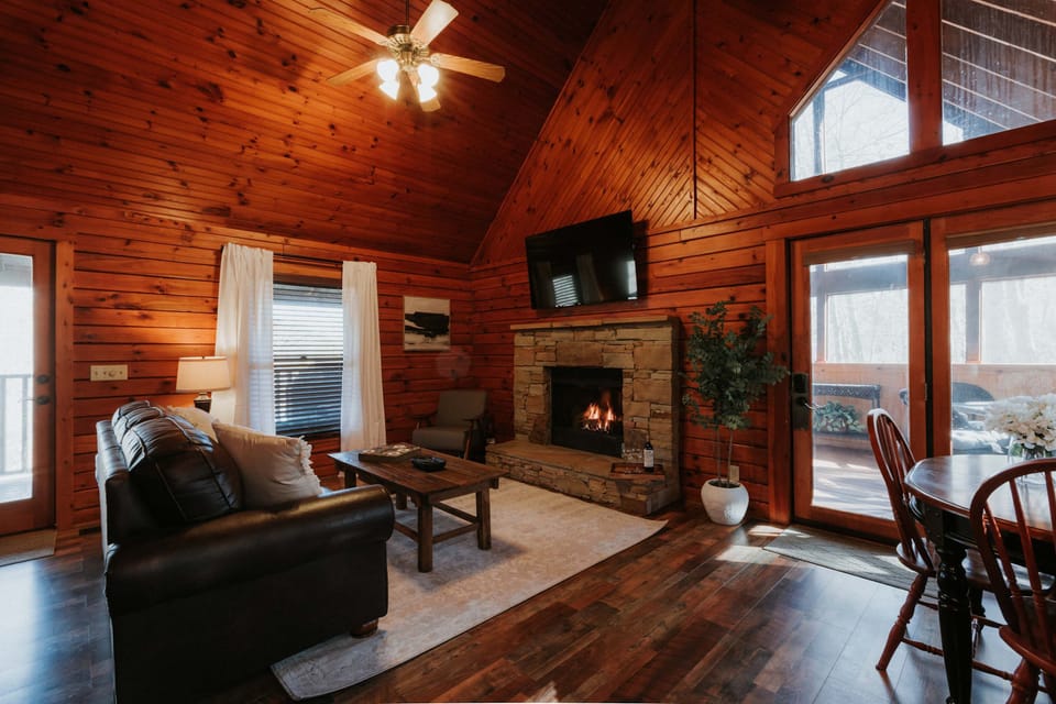 Experience warmth by the stone fireplace with stunning wood accents and bright light!