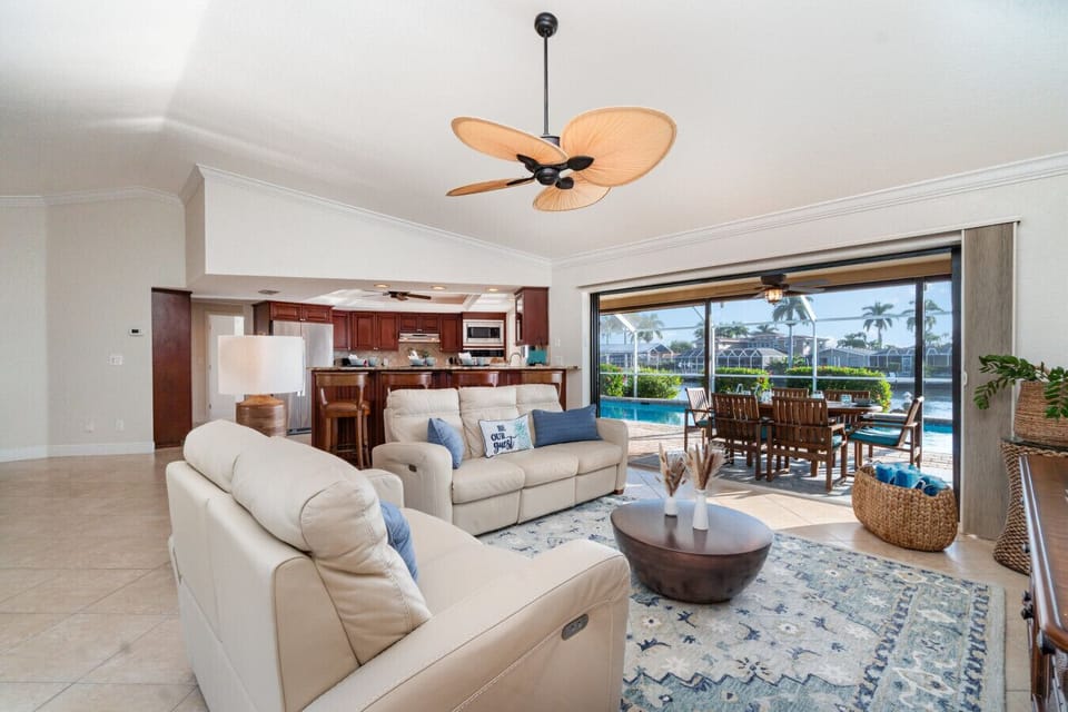 🛋️ Bright open-concept living room with pool & water views
