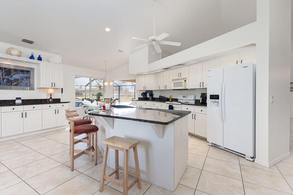Spacious chef’s kitchen with expansive counters and breakfast bar seating. Perfect for gathering, entertaining, and fueling up before a day on the water.