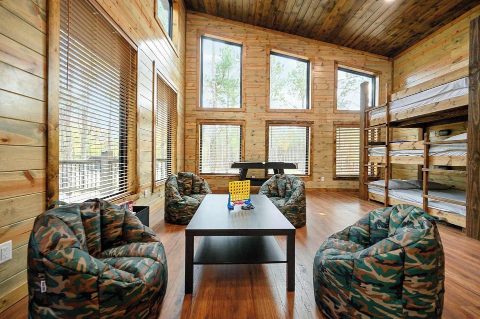 Bedroom 3 with 2 triple full bunk beds, balcony, and Smart TV