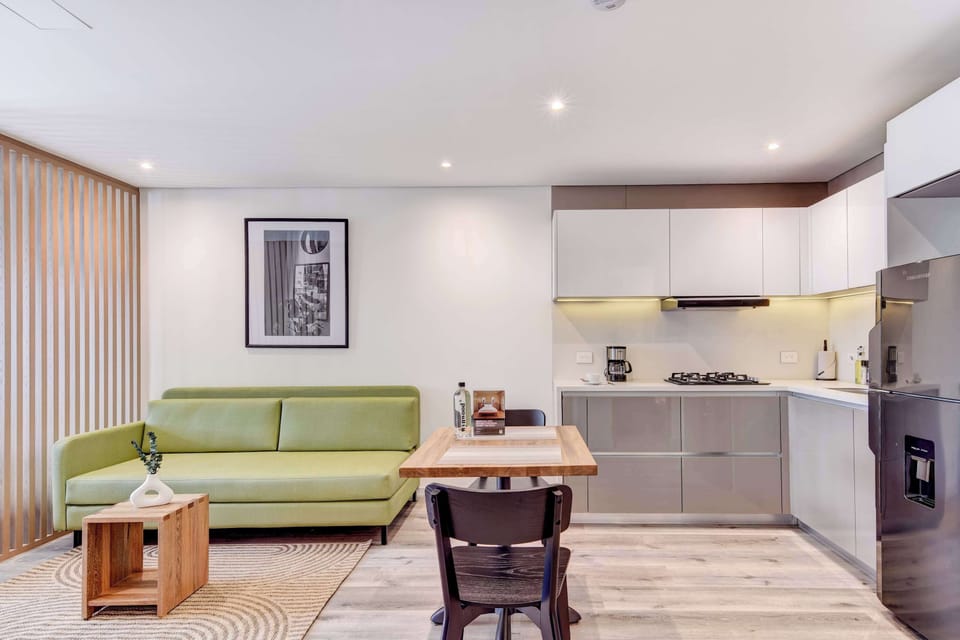 Living room with green sofa and stylish decor