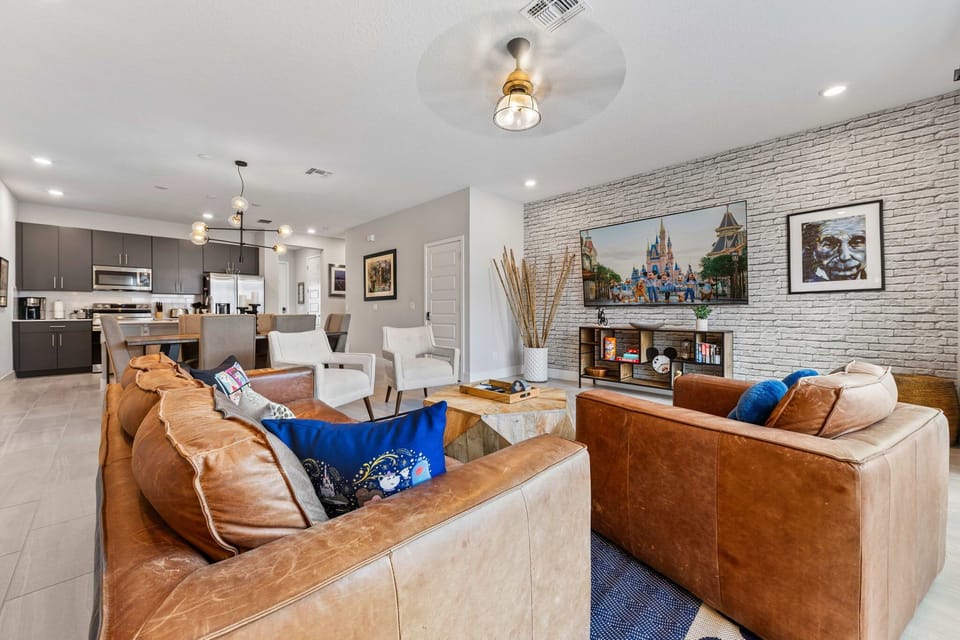 Bright, modern living with plenty of natural light! Relax on the leather sofa or step outside to the private patio for a breath of fresh air.