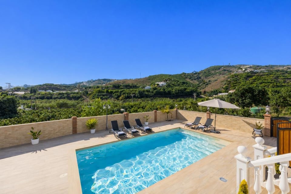 An elevated perspective looking down over the swimming pool, showcasing the expansive, open panoramic views that the terrace provides.