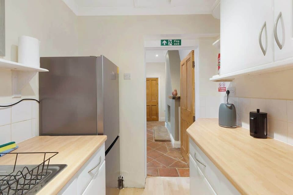 Kitchen equipped with all essentials, including a dryer, oven, fridge and full cookware set.
