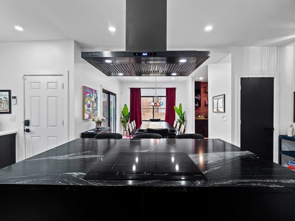 Bold entry hallway w/ striking colors & art that sets the mood.