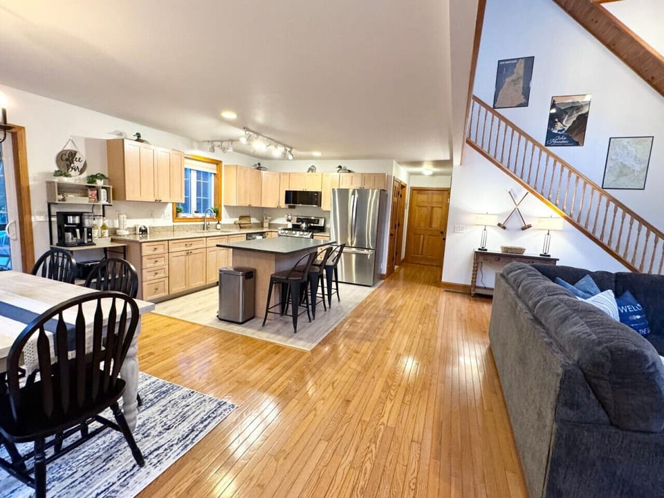 Comfortable living room with fireplace and views of the open kitchen and dining space.