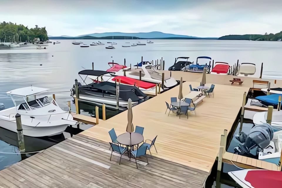 Expansive community dock with seating and stunning Lake Winnipesaukee views.