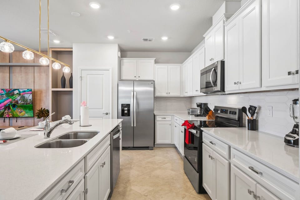 Plenty of prep space and a double sink make cooking easy; stainless fridge, dishwasher, and microwave keep it convenient-serve snacks right to the living area.