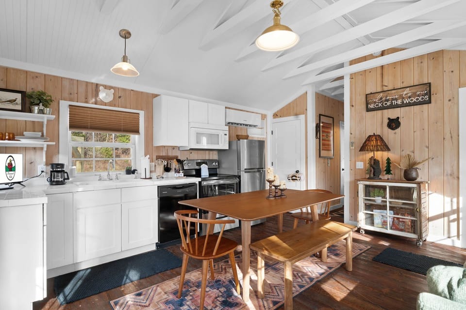 The open concept space features a fully equipped kitchen, along with a dining area and a living room