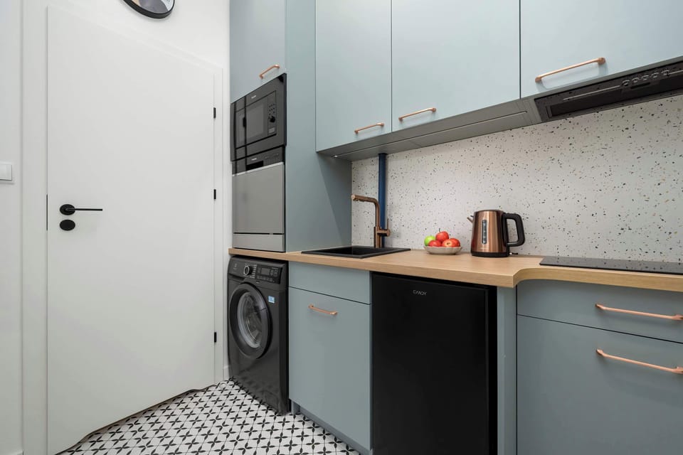 Kitchen space with modern cabinetry, cooktop, and compact design.