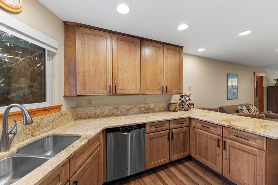 Your gourmet kitchen features granite counters, warm wood cabinetry, and stainless steel appliances—perfect for preparing memorable meals during your stay.