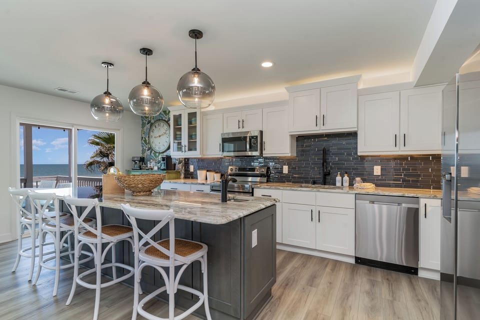 Your gourmet kitchen features stunning ocean views through large windows as you cook with stainless steel appliances and granite countertops.