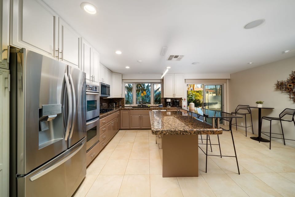 Gather at the bar or enjoy a cozy meal for two in this thoughtfully designed kitchen.