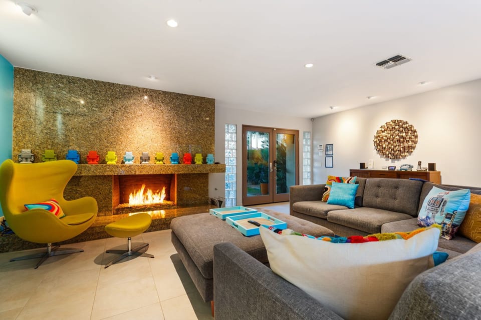 A warm, inviting living room with a glowing fireplace and a sofa made for sinking in and staying awhile.