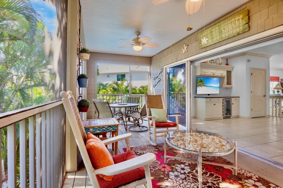 Unwind in your open-concept living space where tropical breezes flow through, creating the perfect blend of indoor comfort and outdoor serenity.