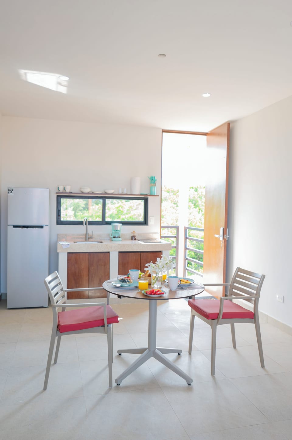 Full-size fridge, stovetop, cookware/dishes/utensils, dining table