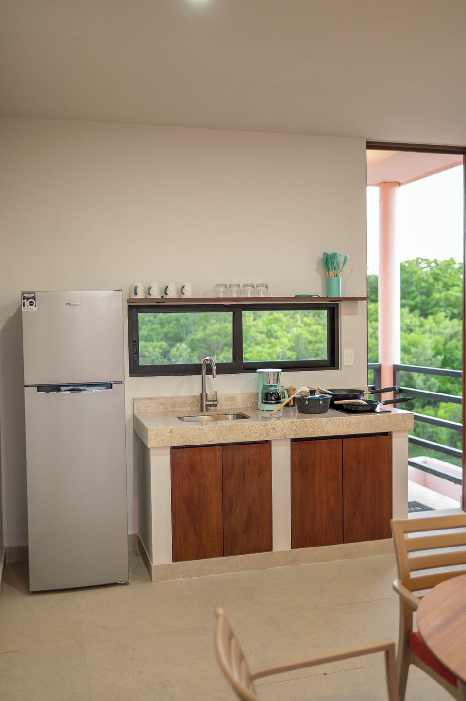 Full-size fridge, stovetop, cookware/dishes/utensils, dining table