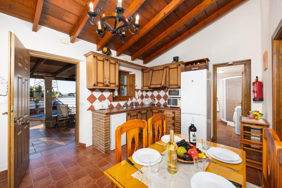 Open-plan living room with sofa, dining area, kitchen, ornamental fireplace, WiFi internet, and satellite TV