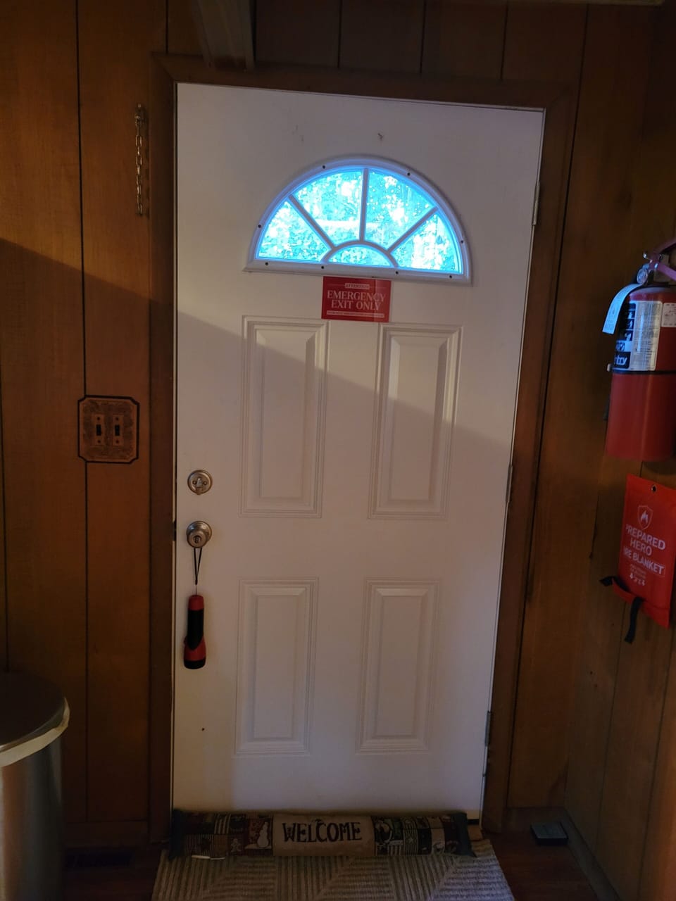 Fire Exit Door. Fire extinguisher and Fire Blanket are on the right hand side of the door.