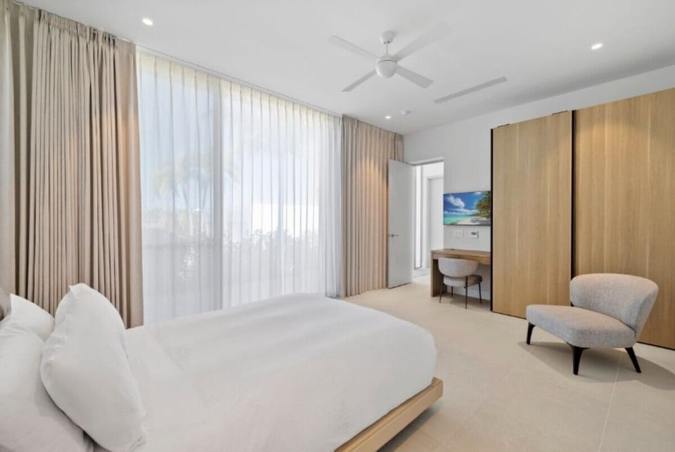 Settle into crisp linens under soft light and quiet comfort.
