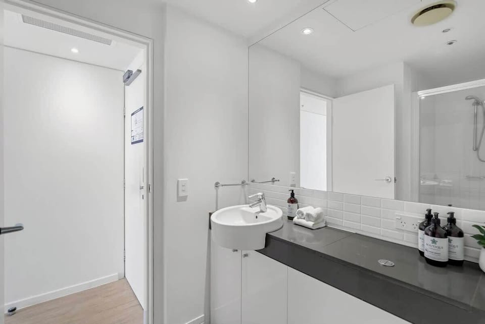 The contemporary bathroom provides a fresh start or calming finish to your day, featuring quality toiletries, ample bench space and a glass-enclosed shower.