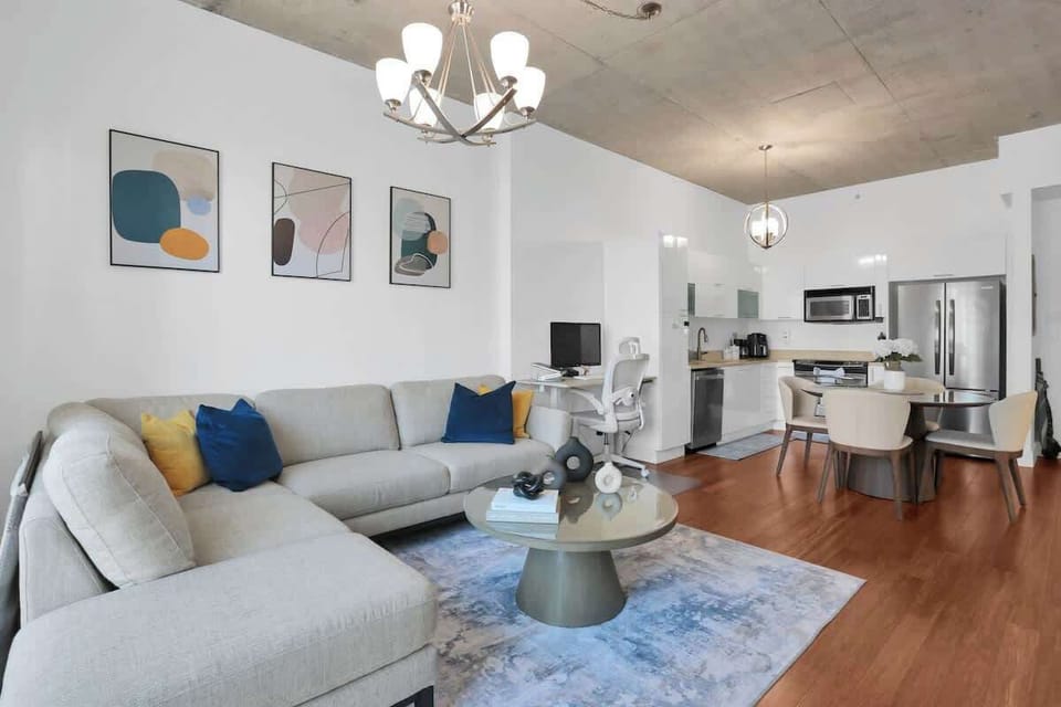Living room with Smart TV, 2 work areas, spacious sofa, city view.