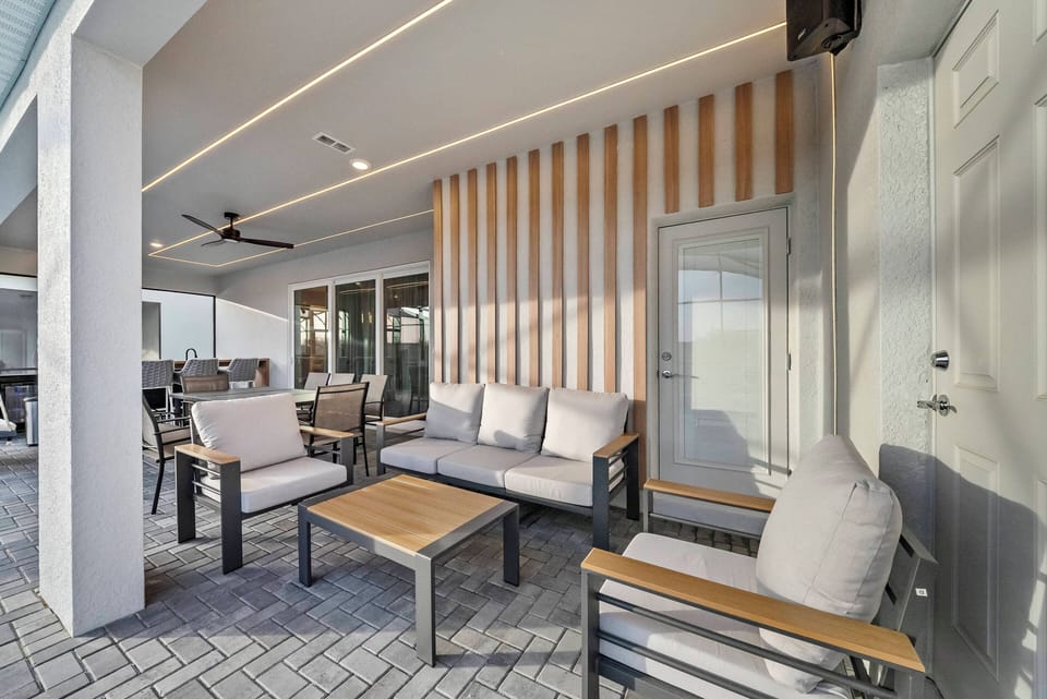 Enjoy this chic outdoor lounge with soft gray cushions and warm wooden accents, ideal for quiet mornings or evening gatherings, all while basking in natural light for a truly relaxing experience.
