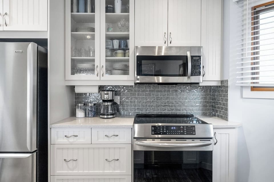 Full kitchen with a drip coffee maker, kettle, and all essentials (coffee grounds, sugar, tea, ketchup, mustard & relish.)